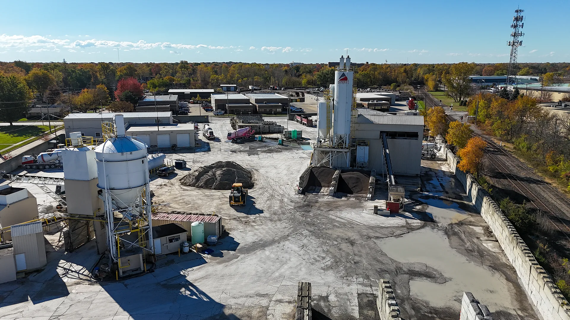 Superior Materials' Ready-mix Concrete - aerial view of a plant yard with cement silos, aggregate stockpiles and mixer trucks